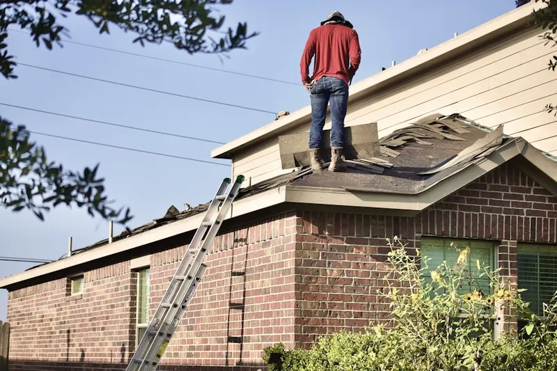 Professional roofer working on a residential roof in Rockyford